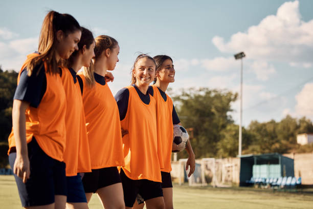 istock Happy soccer player and her teammates on playing field. 1420056784