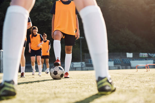 istock Unrecognizable female soccer player getting ready to kick the ball during practice on playing field. 1420056822