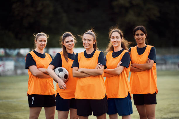 istock Confident women's soccer team on playing field looking at camera. 1420058116