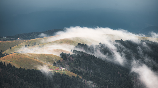 Landscapes of a hill ridge with enveloping clouds