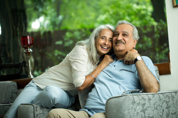 Senior Couple Relaxing At Home Senior Woman Lays Her Head On Her Husband's Shoulder While Relaxing Together At Home south asia stock pictures, royalty-free photos & images