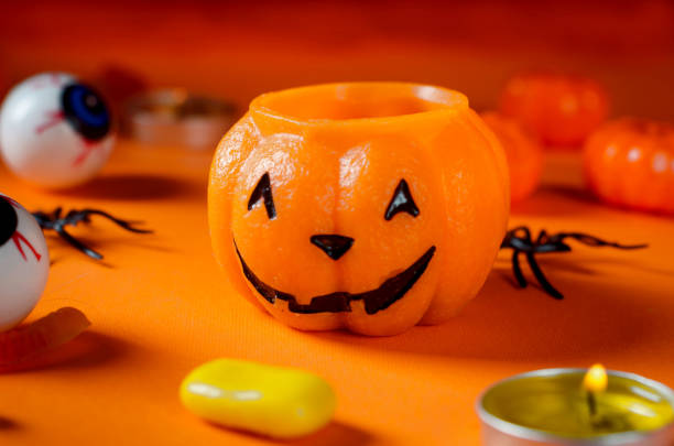 istock Halloween concept with a pumpkin, ,candles and toy spider 1420063489