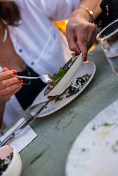 istock a women is taking mediterrian appetizer luxury ambiance focus on foreground 1420063775