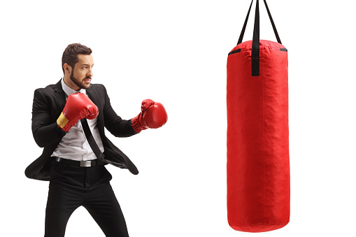 Businessman training box with a punching bag isolated on white background