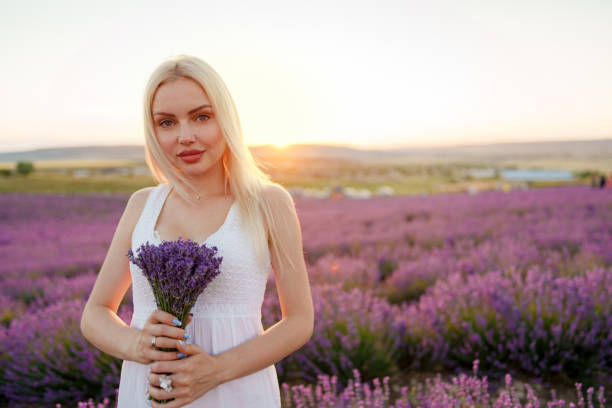 istock Blond haired girl standing in lavender field 1420064964