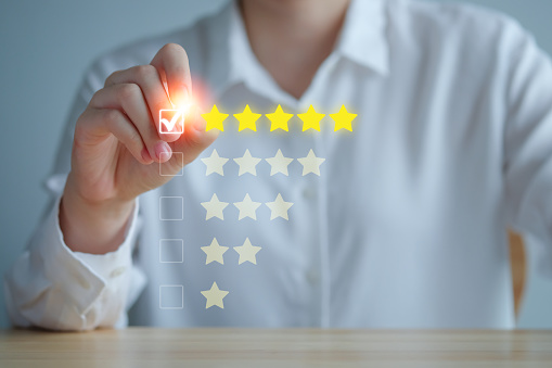 Customer Experience Concept. Review, increase rating or ranking, evaluation, feedback and classification concept. Businesswoman tick checkmark on checkbox for five yellow stars to rating review.