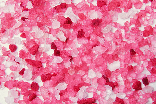 Magnesium pink spa salt scattered on the spa marble floor. Abstract backgrounds and templates