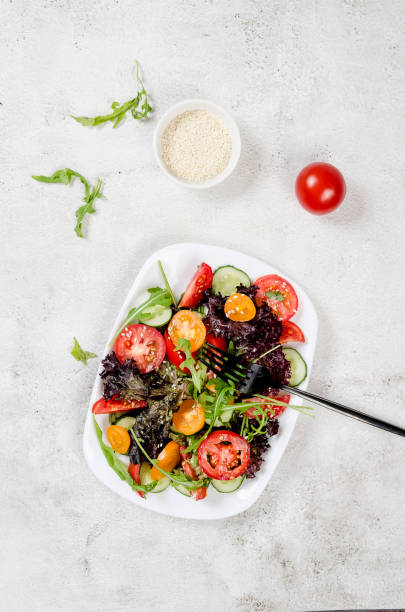 istock salad with fresh salad leaves, arugula, cherry tomato, cucomber 1420067704