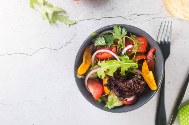 istock salad with fresh salad leaves, arugula, cherry tomato, cucomber 1420067711