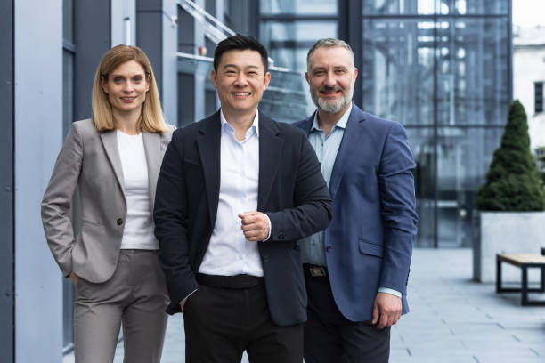 istock Successful diverse business team, three workers smiling and looking at camera, dream team 1420067882