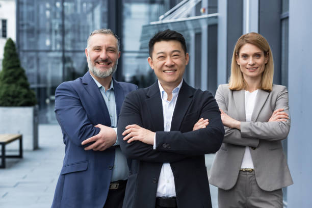 istock Successful diverse business team, three workers smiling and looking at camera, dream team 1420067893