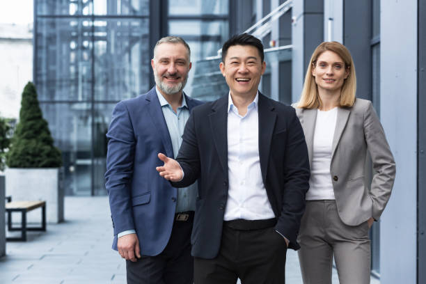 Successful diverse business team, three workers smiling and looking at camera, dream team