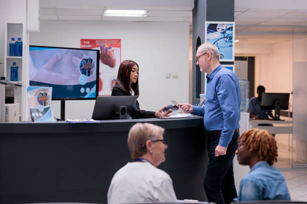istock Old man paying consultation with credit card 1420068408
