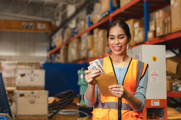 worker employee recieve salary with working overtime bonus money payday work in factory warehouse - bônus imagens e fotografias de stock