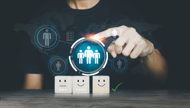 hand touching showing sad and happy smileys on wooden cube. Customer satisfaction. Management to describe the selection of leaders and staff. Enterprise Resource Planning ERP stock photo