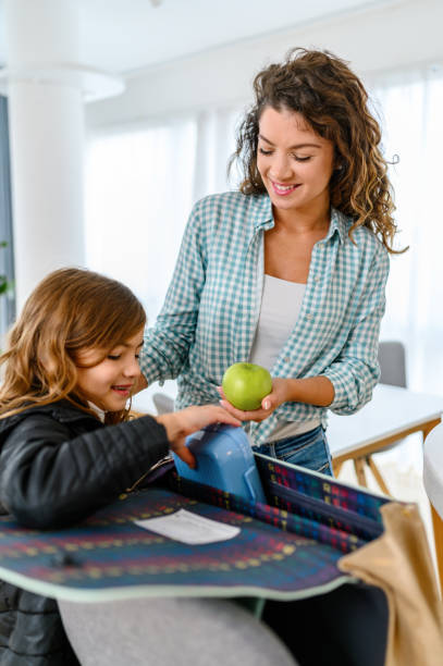 school child taking lunch box from her mother - child human hand sandwich lunch box imagens e fotografias de stock