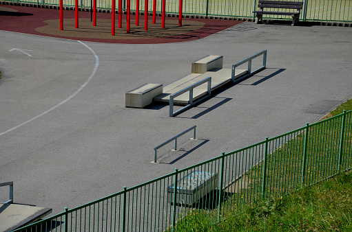 Skateboard park with concrete cement surface with concrete skateboard obstacles is designed for roller sports. Cycling is not allowed except for freestyle bikes. Protective clothing, head, elbow knee