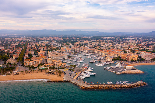 Aerial cityscape of France city Frejus with yachts in harbor