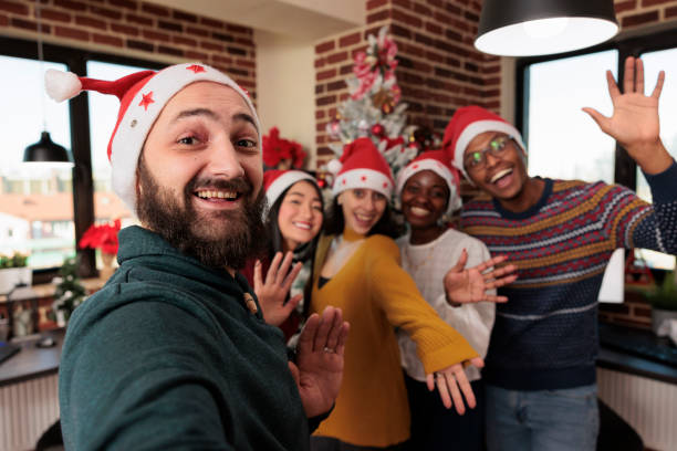 istock Diverse group of people taking pictures with christmas tree 1420075109