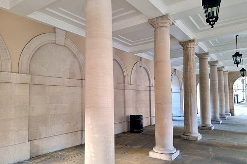 Beautiful light concrete columns against the background of the building