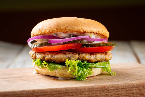 istock Chickenburger with pickles on the wooden board 1420079492