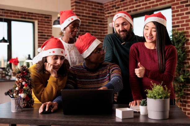 istock Multiethnic team of people using laptop in festive office 1420079501