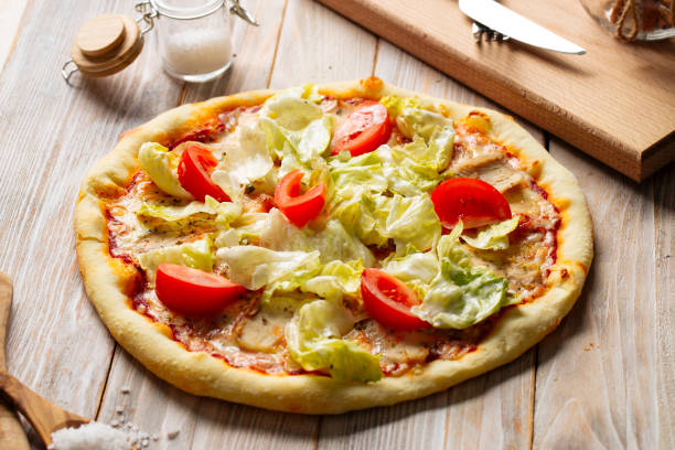 istock Chicken caesar pizza with tomatoes and lettuce 1420079629