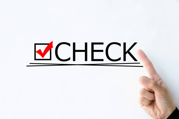 Business man's hand pointing at "CHECK" word on white board stock photo