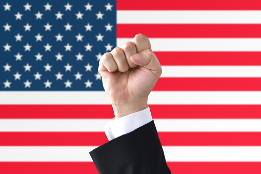 Business man's fist on American flag background