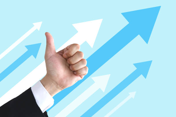 istock Business man's thumbs up with upward arrows 1420079982
