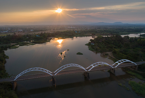Aerial landscape view in the evening with the beautiful arch bridge at Tak, Thailand