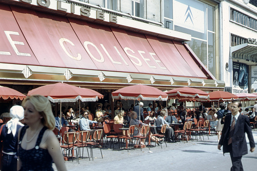 Paris, France, August 05, 1974 - Customers relaxing at outside pavement tables at the Le Colisee cafe, 44 avenue des Champs Elysees, Paris, France.