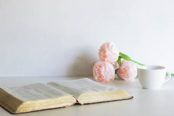 istock Pink roses with coffee cup with books over the white wall. 1420084681