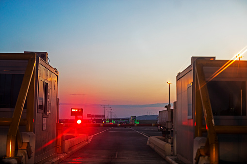 turnstiles for passage to the toll road along the Atoban at sunset. Trave