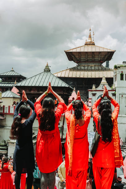 Kathmandu,Nepal - Aug 8, 2022 : Hindu devotees offering paryers to god with Namaste at Pashupatinath Temple. It is one of the most popular and biggest Hindu Temple in the world.