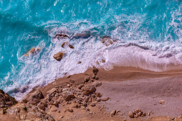 istock Rocky beach nad waves on turquoise sea 1420089305