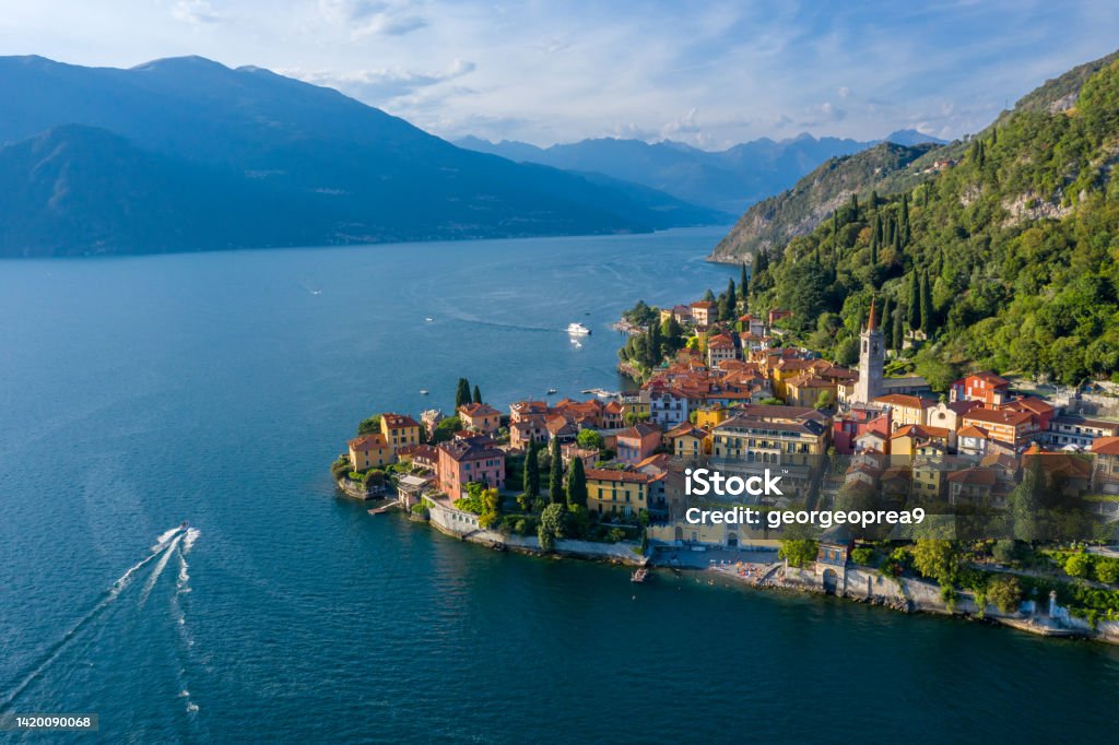 Village of Varenna on Como lake in Italy. Varenna by Lake Como in Italy, aerial view of the old town with the church of San Giorgio in the central square. Famous mountain lake in Italy Lake Como Stock Photo