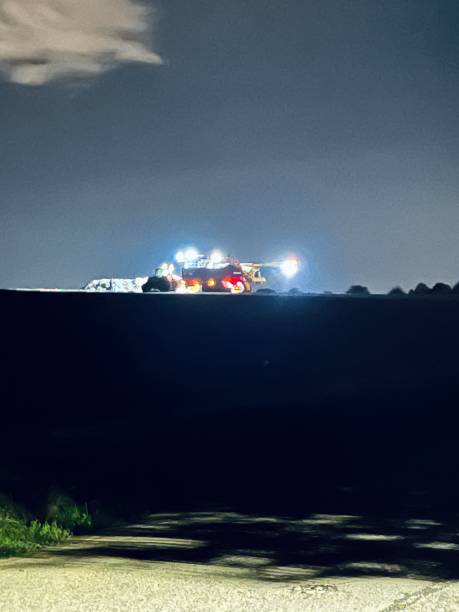 istock Machine harvest at night on the field 1420092741