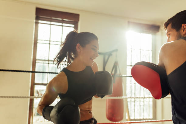 istock Happy female boxer sparring with instructor 1420095016