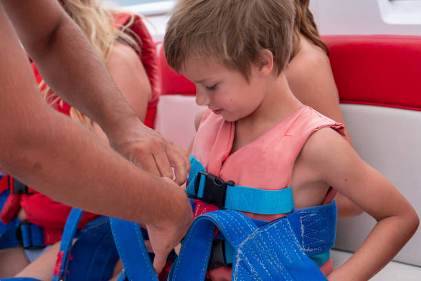 istock Close up father fastening son life vest 1420096480
