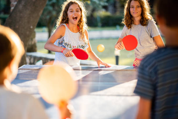 istock Children playing table tennis on summer day 1420096600
