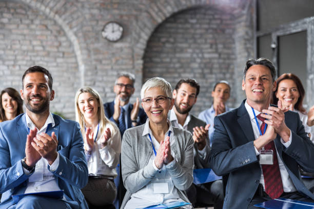 istock Happy entrepreneurs applauding on education event in board room. 1420096656