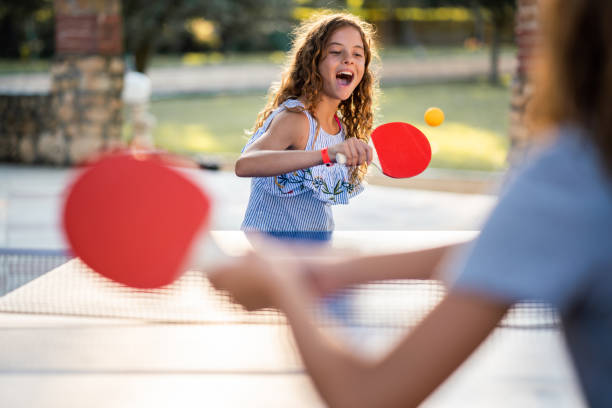 istock Girls playing table tennis on summer day 1420097314