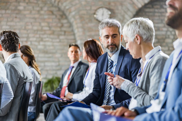 istock Business people talking while having a seminar in board room. 1420098301
