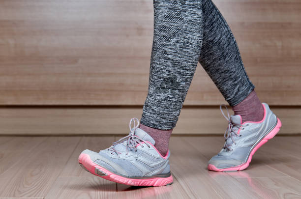 istock Fit female leg in sport shoe step 1420098998