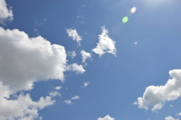 istock White clouds against the blue daytime sky. Natural background. 1420104699