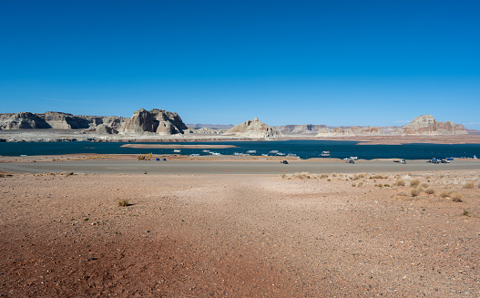 Aerial panorama view of the boats at Lake Powell near the city of Page on the border of Arizona and Utah, southwest USA. The water is a lot lower than it used to be due to climate change and high consumption of water.