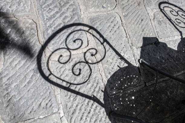 Shadow of Metal Chair on Old Genoa Streets, Italy stock photo