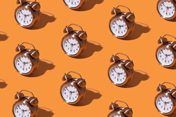 istock Pattern of an alarm clock on a colored background. Monochrome time concept 1420111437