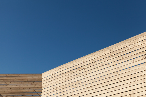 Abstract wooden architecture background, inner corner is under blue sky on a sunny day